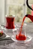 Tea being poured into a glass from a teapot. Náhľad obrázku produktu