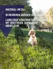 A dog is inside a black metal dog enclosure in a grassy outdoor area. Produktbild-Vorschau