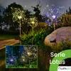 Solar garden lights shaped like fireworks are illuminated at night in a garden setting. Produktbild-Vorschau