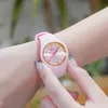 A close-up shot of a person's wrist wearing a pink watch. Produktbild-Vorschau