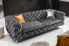 A tufted velvet sofa in a modern living room. Náhled obrázku produktu