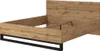 A bed frame with a wooden headboard and frame, supported by black metal legs. Náhled obrázku produktu