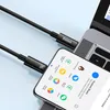 A black USB-C to USB-C cable is shown connecting a smartphone to a laptop. Náhľad obrázku produktu