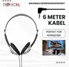 A person is watching TV while wearing headphones, with a graphic overlay highlighting product features. Produktbild-Vorschau