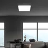 A modern living room with a large window overlooking a mountain landscape, featuring a dining table and chairs, and a ceiling light. Náhľad obrázku produktu