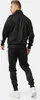 A man wearing a black tracksuit with white stripes on the sides, shown from the back. Anteprima dell’immagine prodotto