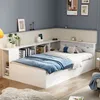 A white multifunctional single bed with storage is set up in a room with blue walls and a light beige headboard. Produktbild-Vorschau