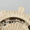 A close-up view of a wooden perpetual calendar mechanism with engraved numbers and markings. Anteprima dell’immagine prodotto