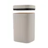 A beige trash can with its lid hovering above it, against a white background. Podgląd zdjęcia produktu