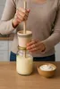 A person is making butter in a kitchen setting. Produktbild-Vorschau