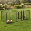 A dog pen set up on a grassy lawn with a wooden dog bowl stand inside. Podgląd zdjęcia produktu