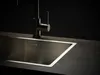 A close-up shot of a stainless steel sink and faucet. Produktbild-Vorschau
