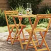 A wooden table and chairs set in an outdoor garden setting. Produktbild-Vorschau