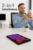A man is using a phone while a tablet is charging on a desk. Produktbild-Vorschau
