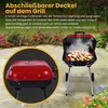 A red and black charcoal grill with food cooking inside, set on a patio with flowers in the background. A close-up inset shows the lid of the grill. Produktbild-Vorschau