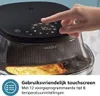 A hand is shown interacting with the touchscreen of a black air fryer, with food visible inside. Náhľad obrázku produktu