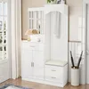 A white entryway storage unit with a mirror, coat rack, bench, and cabinets. Podgląd zdjęcia produktu