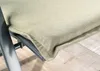 A close-up view of a chair cushion on a metal chair frame. Produktbild-Vorschau