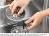 Hands assembling a sink drain component. Produktbild-Vorschau