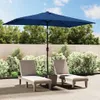 A patio scene with two lounge chairs and a large blue umbrella. Anteprima dell’immagine prodotto