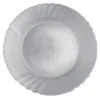 A white plate with a decorative rim is shown from a top-down view against a white background. Anteprima dell’immagine prodotto