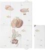 A folded baby changing mat with a watercolor illustration of a mouse holding balloons and a blimp in the sky. Náhled obrázku produktu