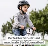 A young boy wearing a helmet rides a balance bike outdoors. Náhľad obrázku produktu
