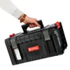 A hand holding a black tool box with red latches. Náhled obrázku produktu