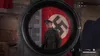 A sniper scope view of a soldier in uniform standing in front of a Nazi flag. Podgląd zdjęcia produktu