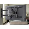 A TV wall mount is attached to a television, which is mounted on a wall in a bedroom setting. Produktbild-Vorschau