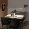 A modern dining room with a table set for a meal, illuminated by a sleek LED pendant light. Produktbild-Vorschau