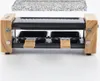 A raclette grill with a granite stone top and two small pans, presented on a white background. Produktbild-Vorschau