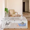 Two puppies are playing inside a white plastic playpen in a living room setting, with a chair and a plant in the background. Náhled obrázku produktu