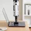 A handheld vacuum cleaner is shown cleaning confetti off a laptop keyboard. Produktbild-Vorschau