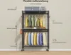 A metal garment rack with clothing and storage boxes, labeled with German text. Voir les images du produit