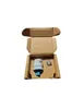 A cardboard box containing a small electronic device and a cap. Náhľad obrázku produktu