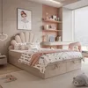 A bedroom scene featuring a bed, desk, and shelves, decorated in soft pink and beige tones. Produktbild-Vorschau