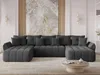 A large, dark gray sectional sofa is arranged in a U-shape in a modern living room. The sofa has a tufted design and is adorned with several dark gray throw pillows. Behind the sofa, a large abstract artwork with marble-like patterns is displayed on a wall