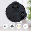 The underside of a black robot vacuum cleaner is shown, with close-ups of its wheels. Below the vacuum are four circular insets showing different types of debris. Produktbild-Vorschau