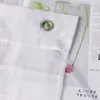 A close-up view of a white fabric curtain with metal grommets, showing the texture and stitching. Produktbild-Vorschau
