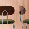 Close-up view of two chairs with wooden backs and green fabric seats, against a wooden background. Anteprima dell’immagine prodotto