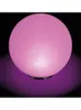 A pink spherical lamp with a purple glow underneath, set against a black background. Produktbild-Vorschau