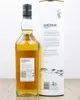 A bottle of An Cnoc 12 Years Old Highland Single Malt Scotch Whisky stands next to its cylindrical packaging. Produktbild-Vorschau