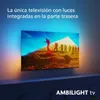 A television displaying a scenic image with people hiking, with ambient lighting emanating from the back of the TV. Produktbild-Vorschau