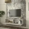 A wall-mounted TV lowboard with open compartments and decorative items. Anteprima dell’immagine prodotto