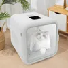 A white pet dryer with a cat inside, placed on a wooden floor next to a plant and a cabinet. Náhled obrázku produktu