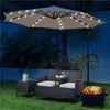 A garden set with a loveseat, side table, umbrella with lights, and a fire pit at night. Produktbild-Vorschau