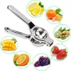 A manual citrus juicer surrounded by various fruits. Produktbild-Vorschau
