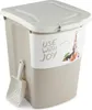 A beige pet food storage container with a scoop attached to the side. Produktbild-Vorschau