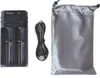 A black universal battery charger with a USB cable and a gray storage pouch are displayed against a white background. Produktbild-Vorschau